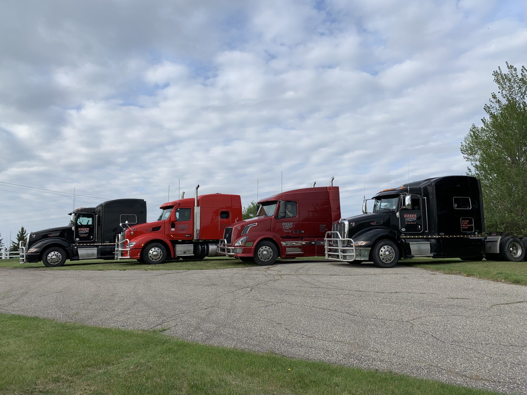 Four Moser Brothers tractors parked in a row